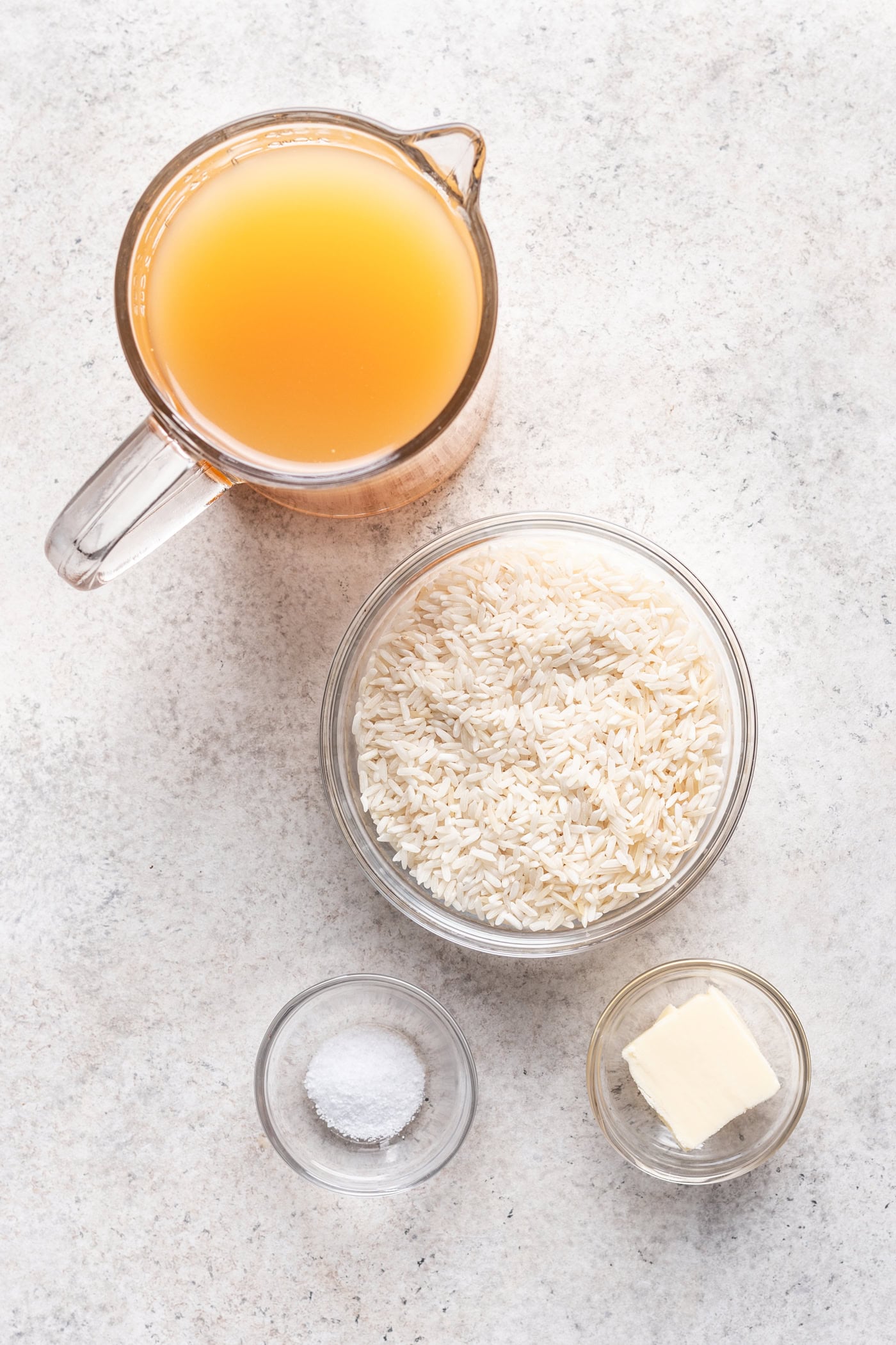four bowls of ingredients on a grey background