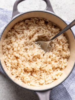 bone broth rice in a large pot with a spoon