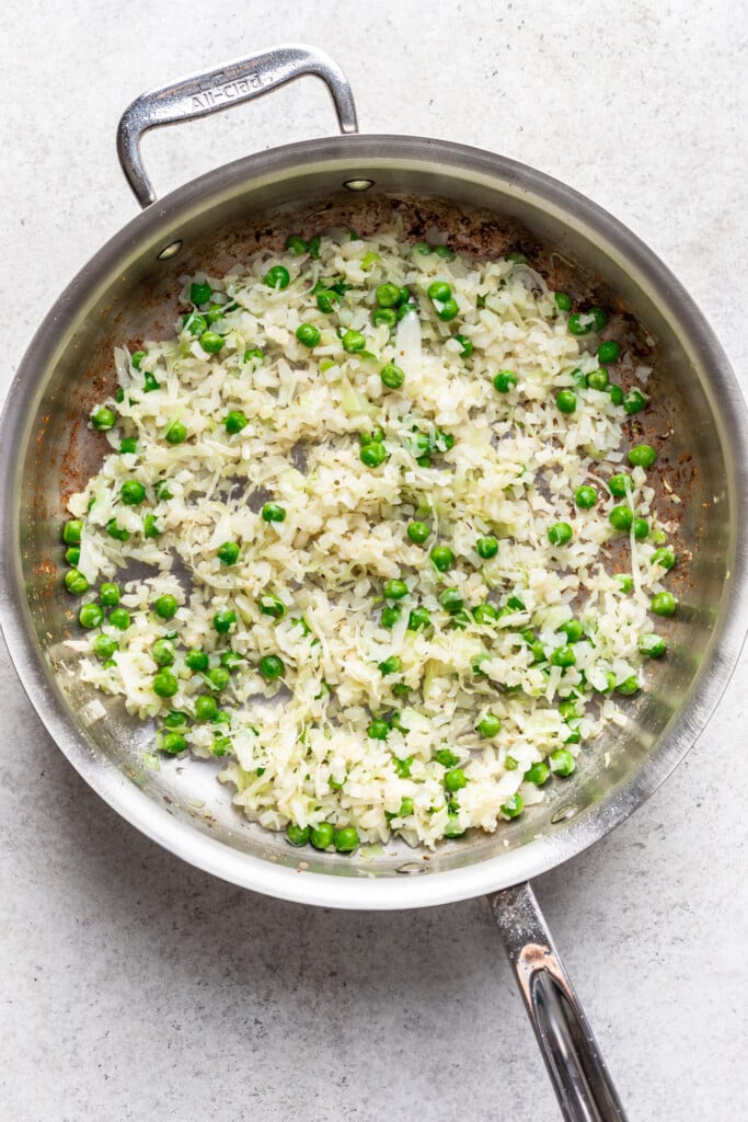 cauliflower rice and peas in a skillet