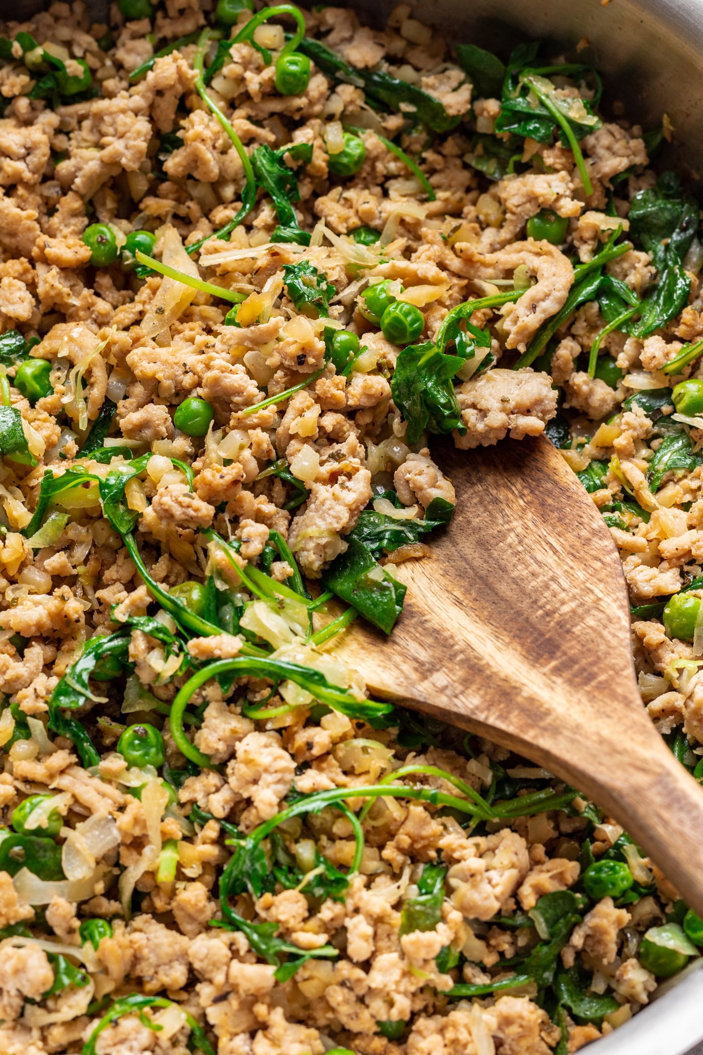ground turkey with veggies and a wood spoon