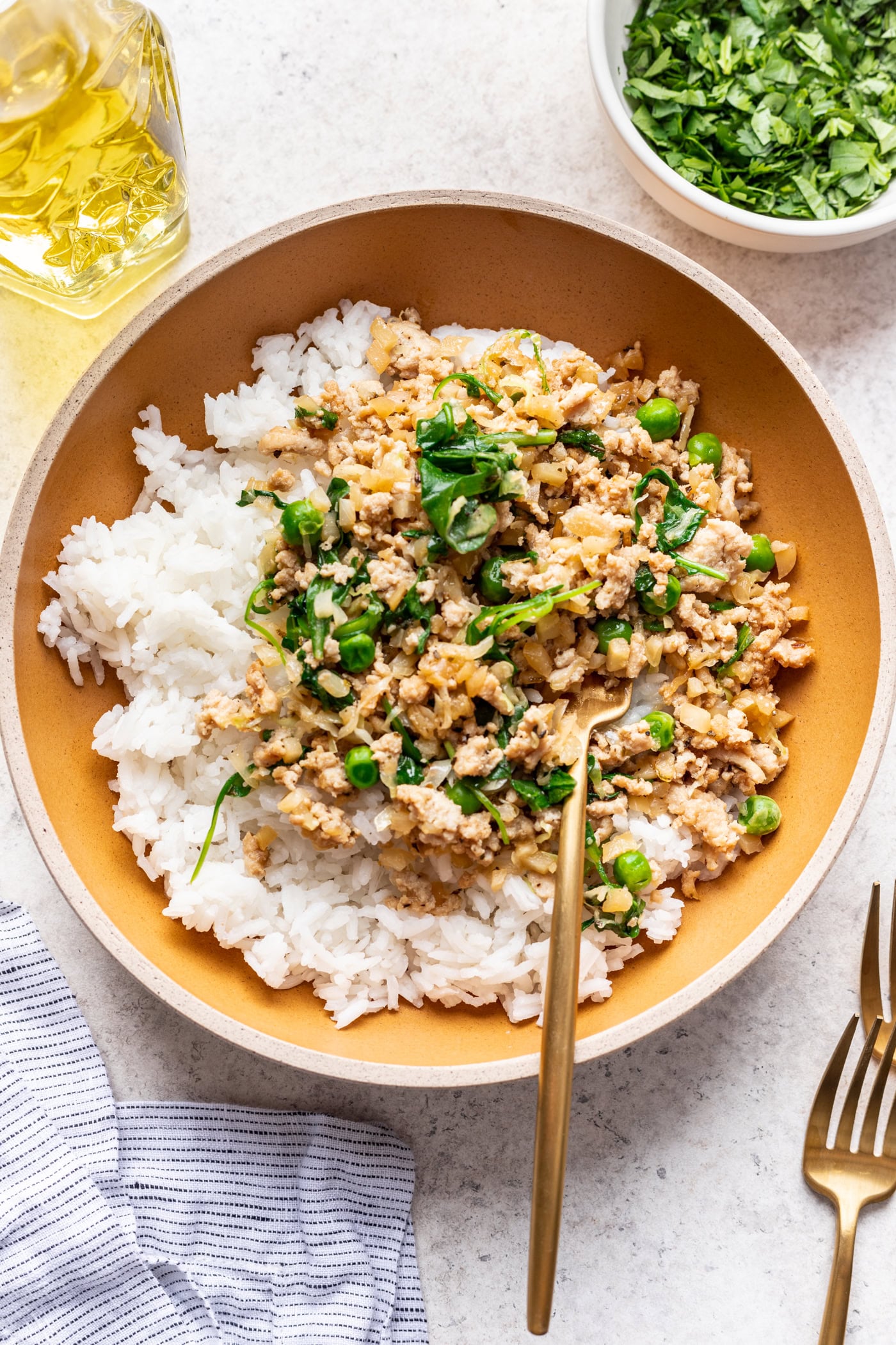 ground turkey and veggies over rice in a bowl with a fork