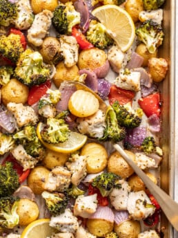 chicken pieces and veggies on a sheet pan