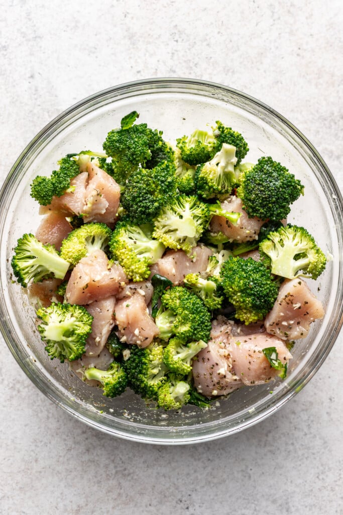 broccoli and chicken pieces in a glass bowl
