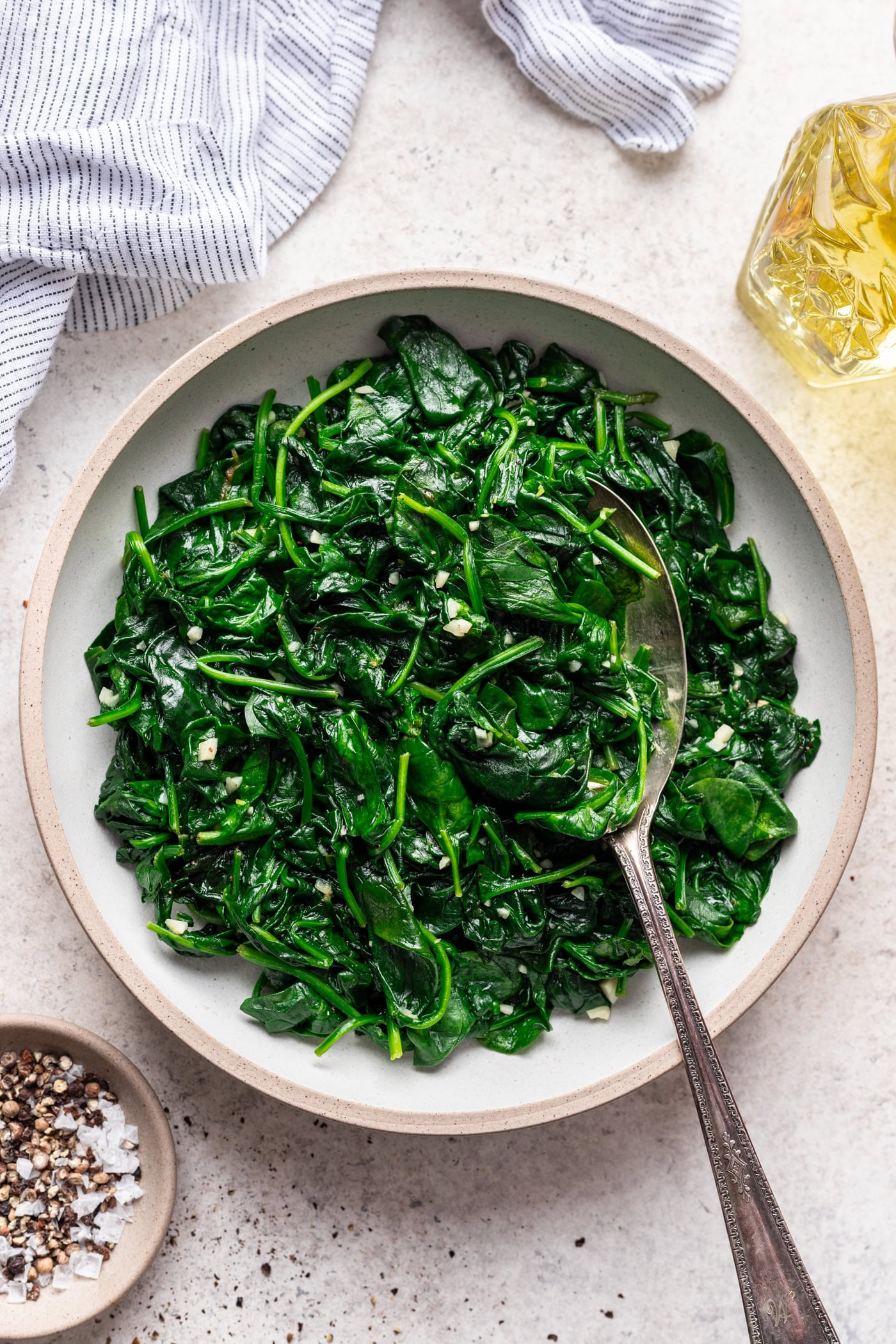 bowl of spinach with a serving spoon