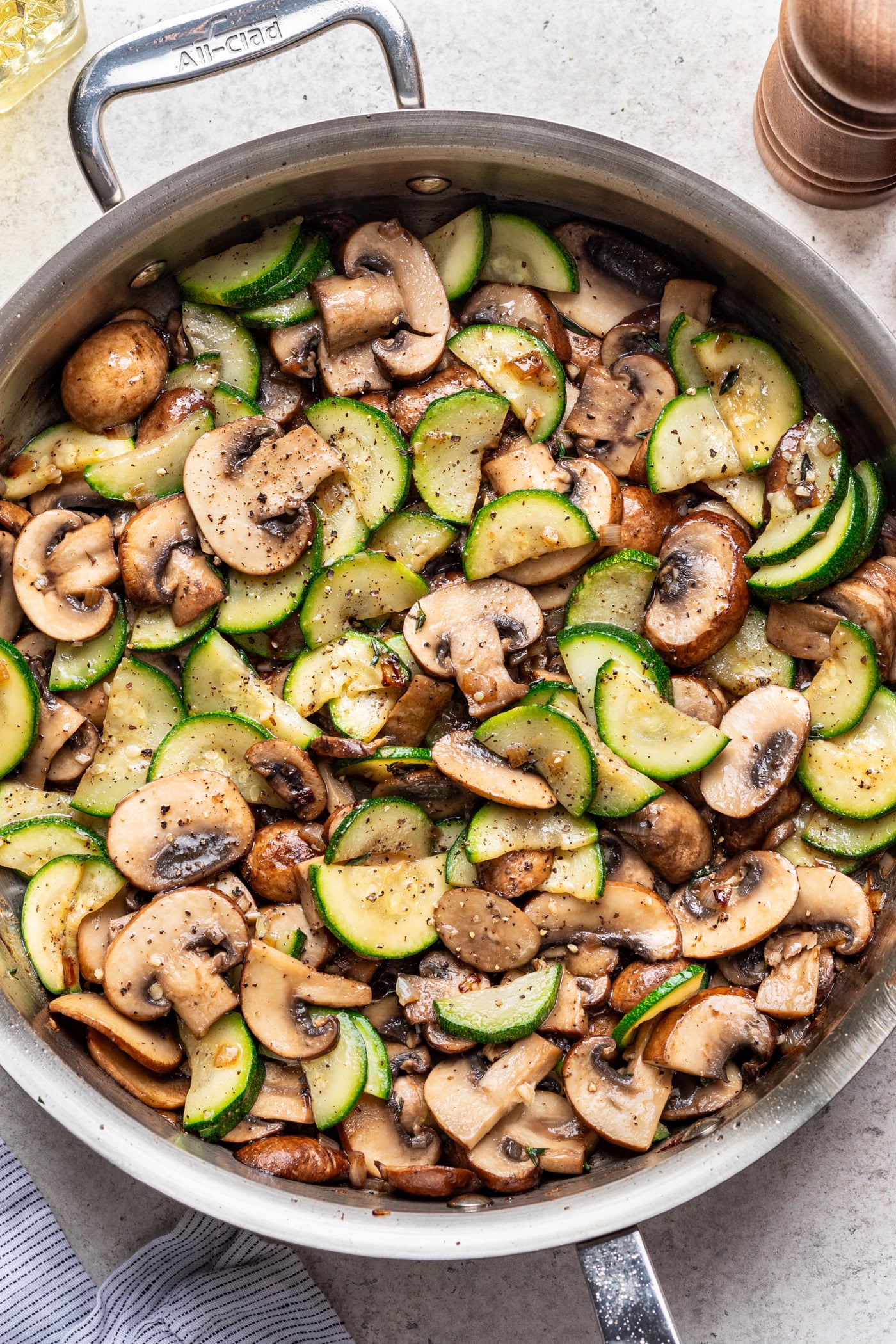 large skillet with sautéed mushrooms and zucchini