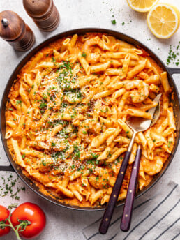 large bowl of pasta with 2 serving spoons