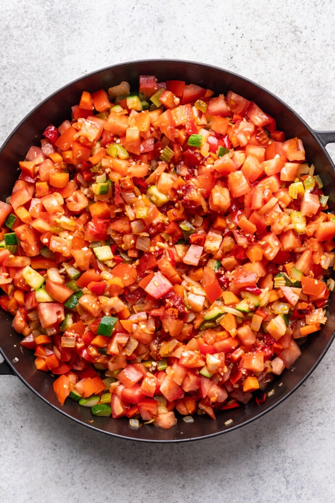A pan filled with chopped vegetables and onions.