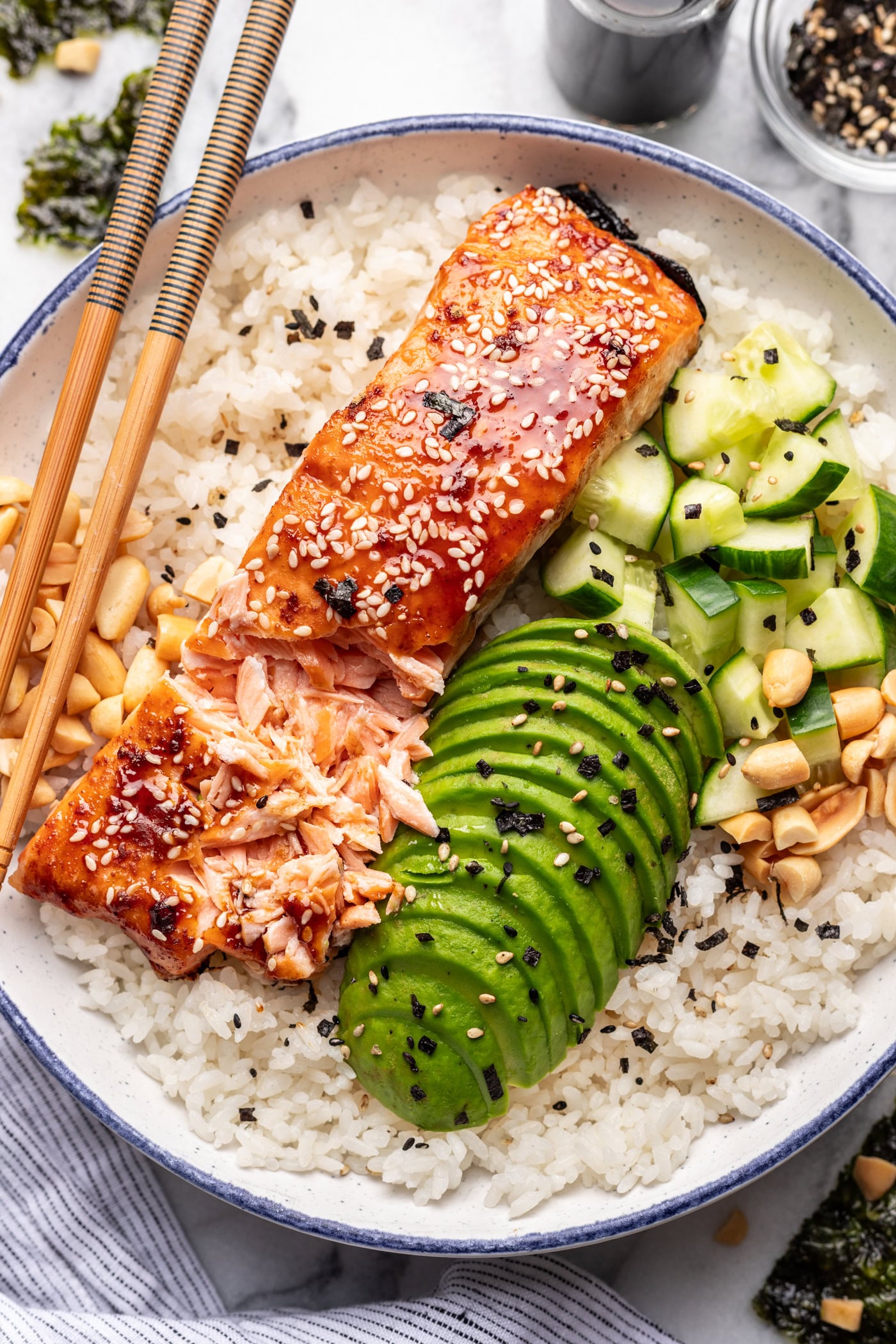 Salmon rice bowl with avocado, cucumber, and sesame seeds
