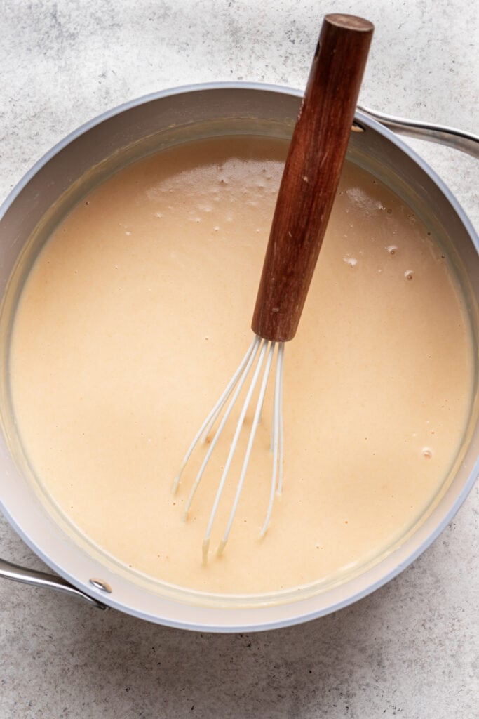 whisk in a pot with melted butter and flour mixture