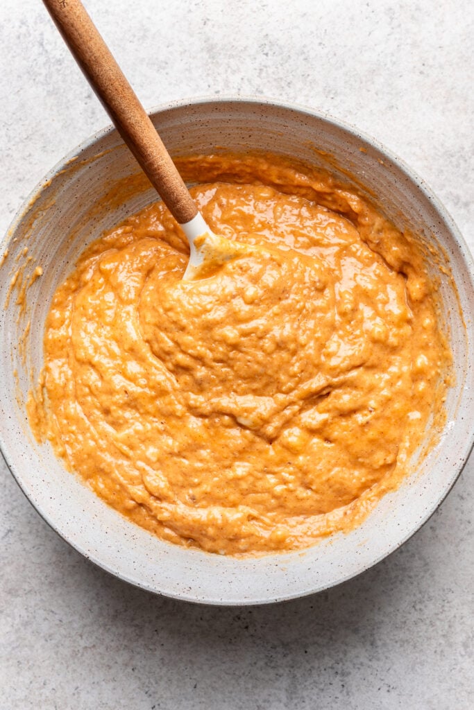 banana pumpkin bread batter in a bowl with a whisk