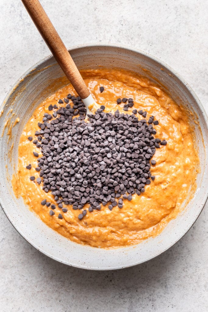 pumpkin banana bread batter in a bowl with chocolate chips
