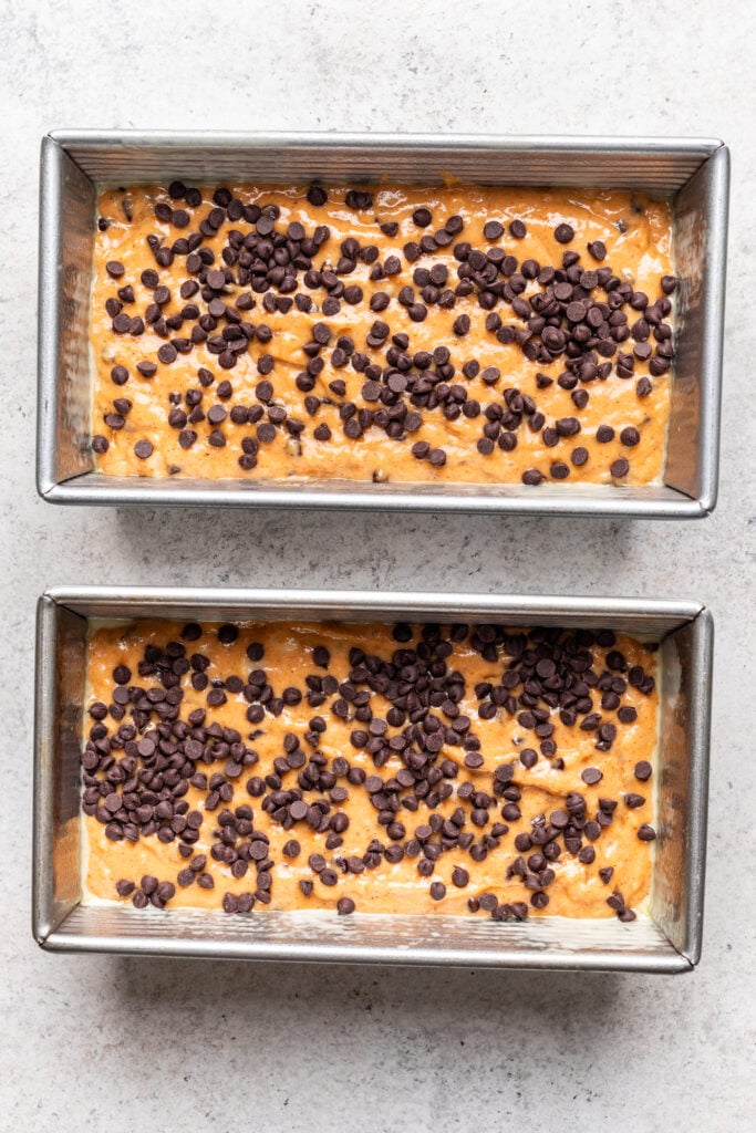 Oven-baked banana bread with chocolate chips in rectangular pans, ready to bake