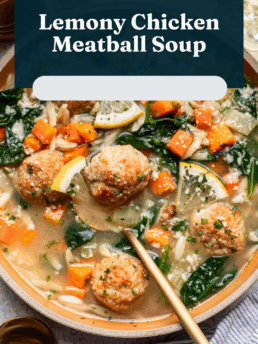 A bowl of lemony chicken meatball soup with carrots, spinach, orzo, and herbs, with a wooden spoon resting in the bowl. Text above reads, “Lemony Chicken Meatball Soup.”.