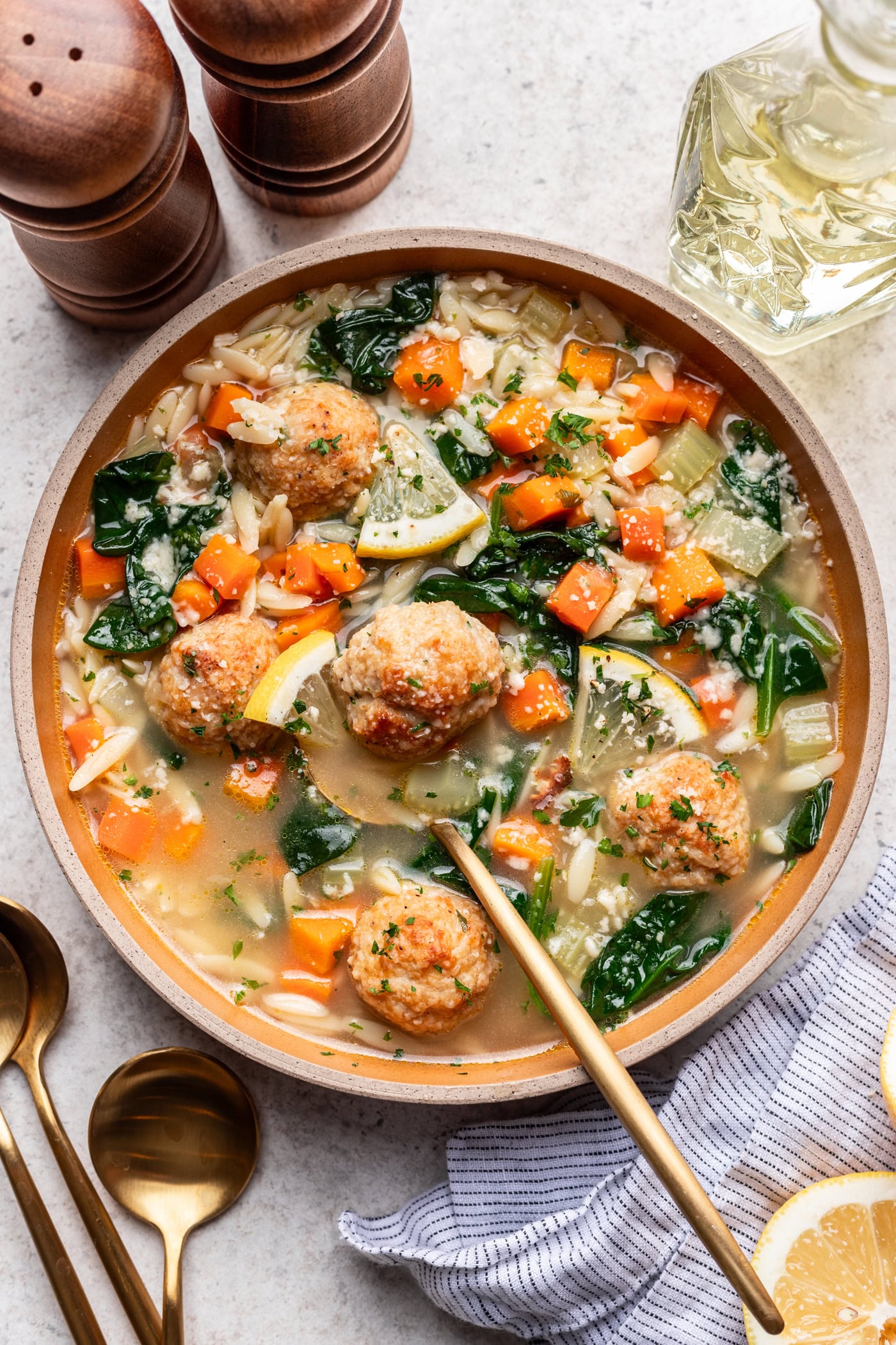 lemony chicken meatball soup in a bowl with a spoon