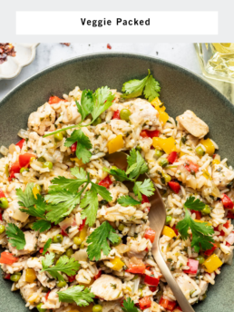 A bowl of chicken and cilantro rice with colorful vegetables, garnished with fresh cilantro, and a gold fork resting in the bowl. The text reads Chicken and Cilantro Rice, Veggie Packed, and Cupcakes And Coffee Breaks.