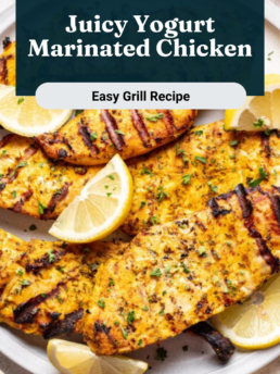 Grilled yogurt-marinated chicken breasts served on a white plate, garnished with fresh parsley and lemon wedges. Text overlay reads Juicy Yogurt Marinated Chicken – Easy Grill Recipe.